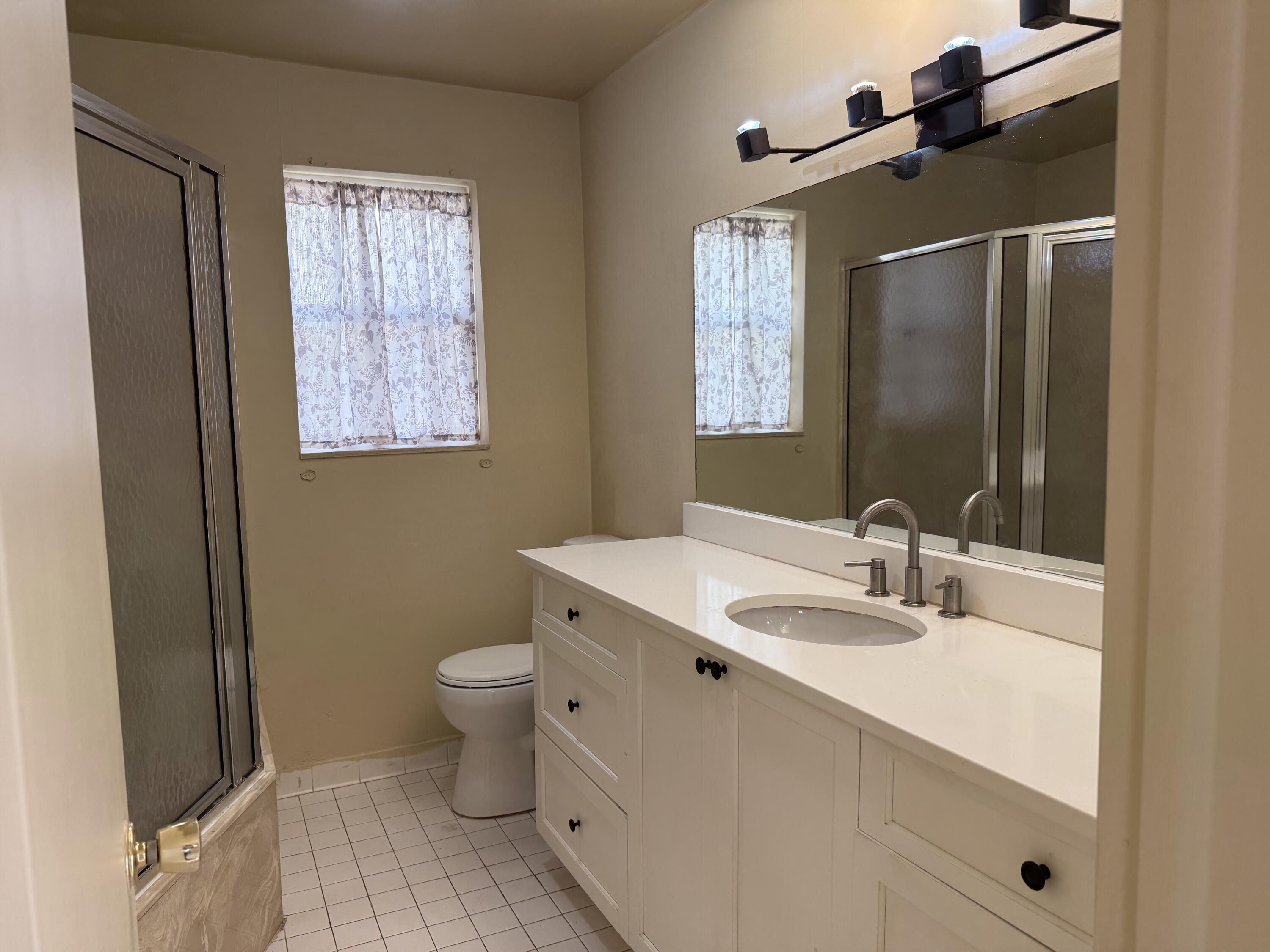 4941 Marbella Road North West Palm Beach, FL 33417 - Photo 3 of 12 a bathroom with a sink toilet and shower