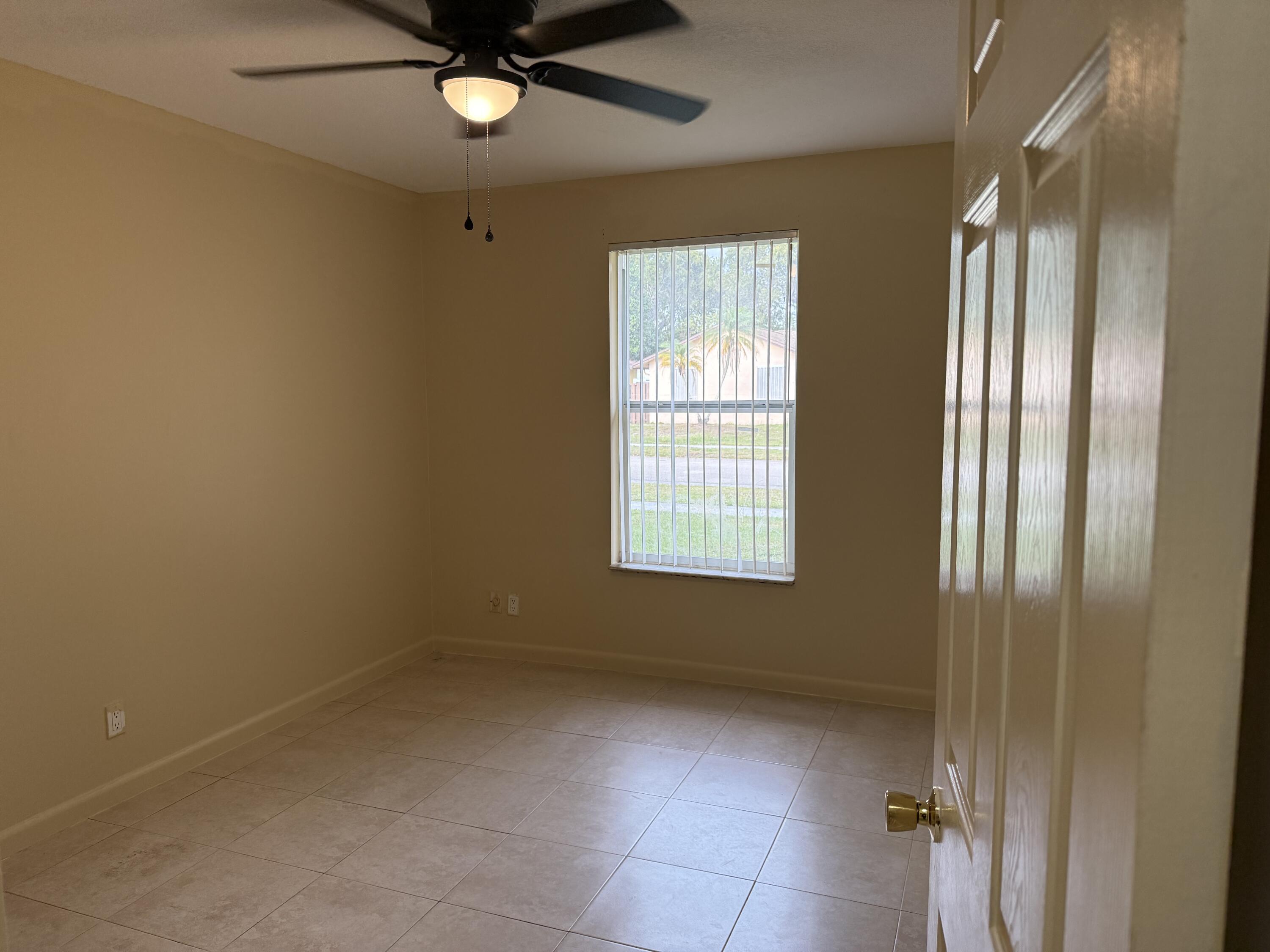 4941 Marbella Road North West Palm Beach, FL 33417 - Photo 7 of 12 a view of an empty room with a window