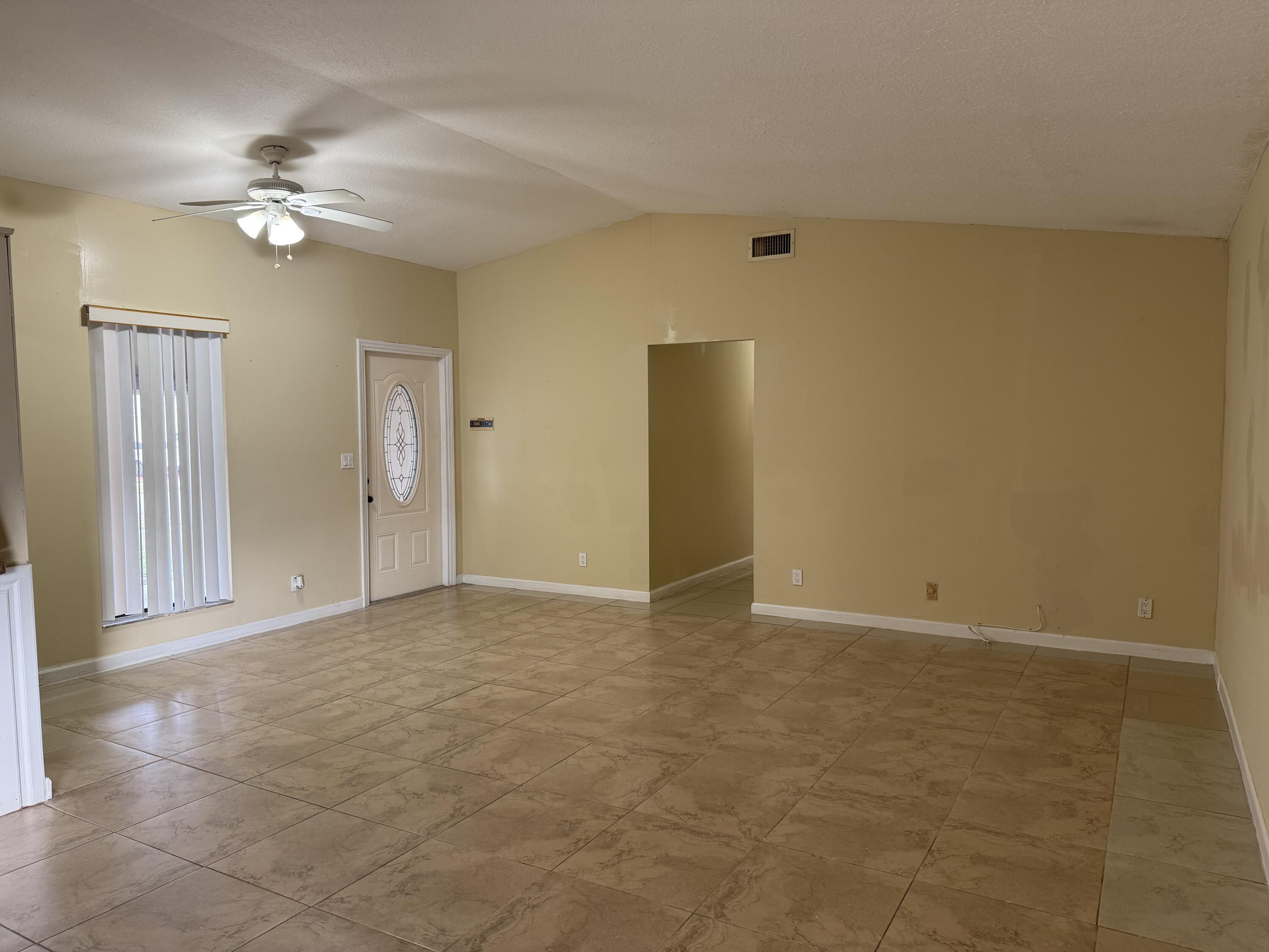 4941 Marbella Road North West Palm Beach, FL 33417 - Photo 9 of 12 a view of a livingroom with a chandelier fan