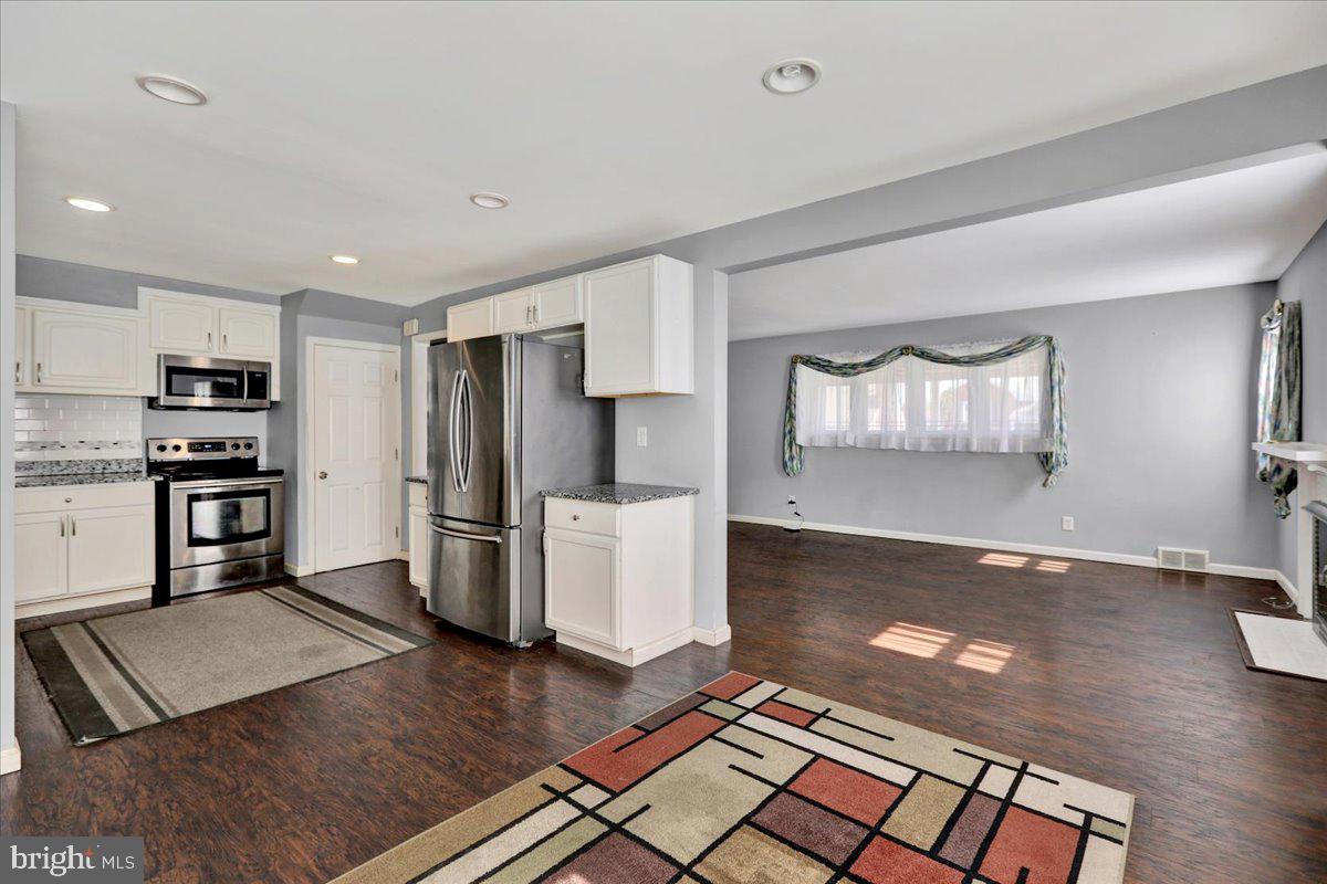 212 Mayer Street Reading, PA 19606 - Photo 12 of 37 a kitchen with stainless steel appliances granite countertop a refrigerator and a stove top oven