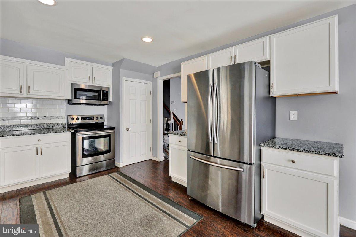 212 Mayer Street Reading, PA 19606 - Photo 13 of 37 a kitchen with granite countertop a refrigerator stove and microwave