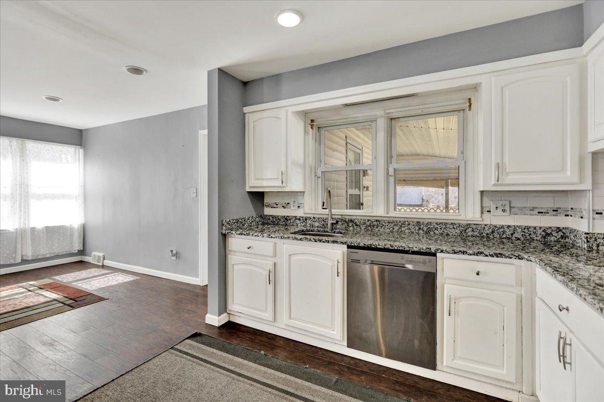 212 Mayer Street Reading, PA 19606 - Photo 15 of 37 a bathroom with a granite countertop sink and a mirror