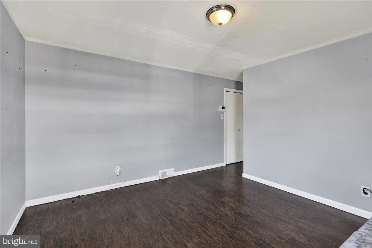 212 Mayer Street Reading, PA 19606 - Photo 22 of 37 an empty room with wooden floor and windows