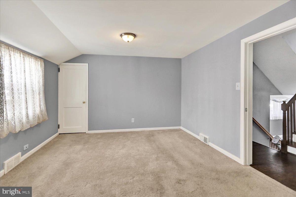 212 Mayer Street Reading, PA 19606 - Photo 24 of 37 a view of an empty room with wooden floor and a window
