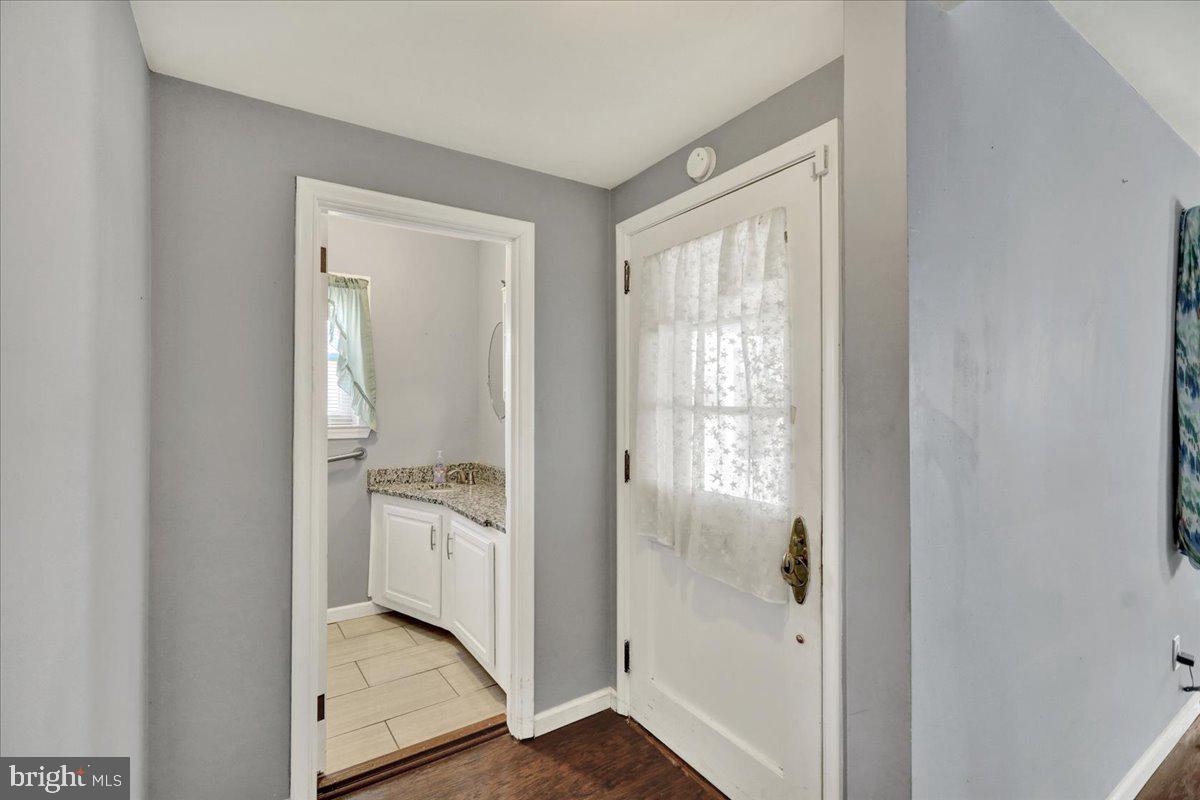 212 Mayer Street Reading, PA 19606 - Photo 6 of 37 a bathroom with a granite countertop sink and a mirror