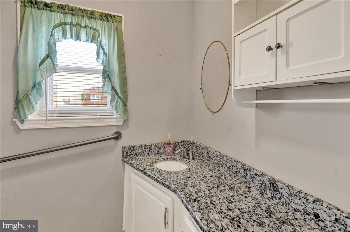 212 Mayer Street Reading, PA 19606 - Photo 7 of 37 a bathroom with a granite countertop sink and a mirror