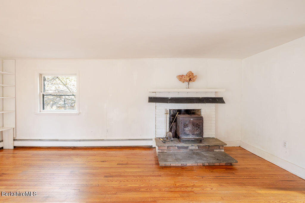 26 Lenox Road West Stockbridge, MA 01266 - Photo 15 of 40 a view of a livingroom with wooden floor and a fireplace