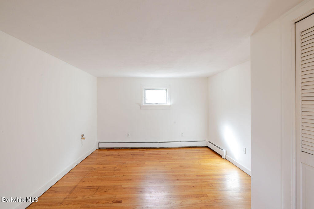 26 Lenox Road West Stockbridge, MA 01266 - Photo 24 of 40 an empty room with wooden floor and windows