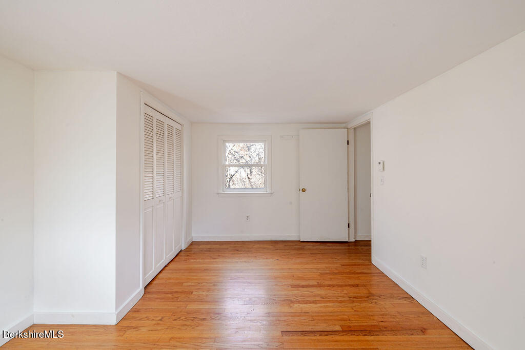 26 Lenox Road West Stockbridge, MA 01266 - Photo 25 of 40 a view of an empty room with wooden floor and a window