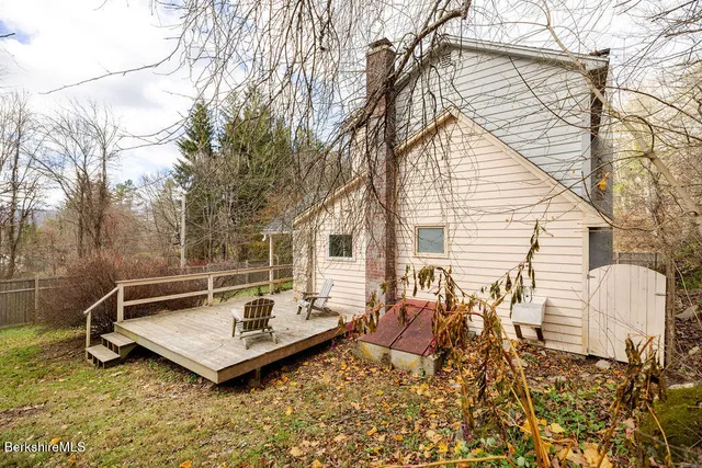 a view of a backyard with a large tree