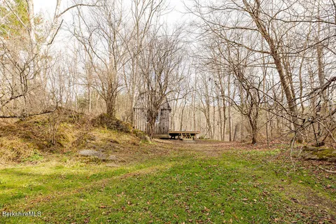 a view of yard with tree and wooden fence