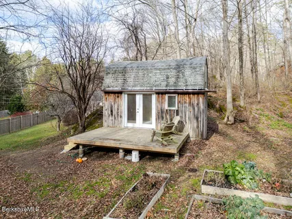 a view of backyard with deck and garden