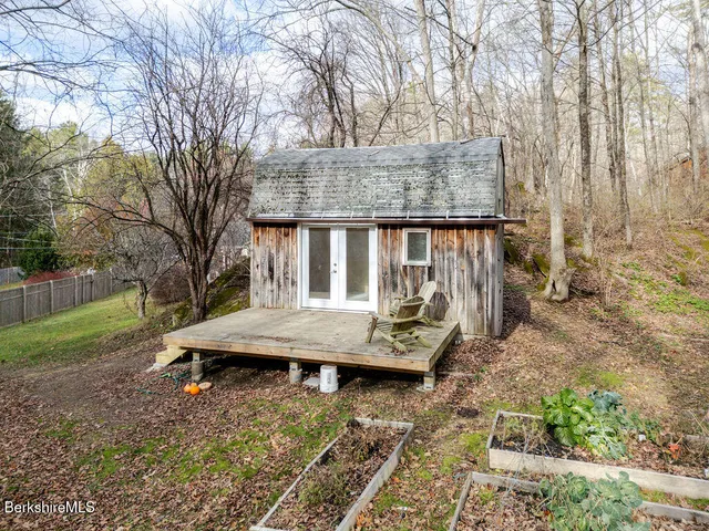 a view of backyard with deck and garden