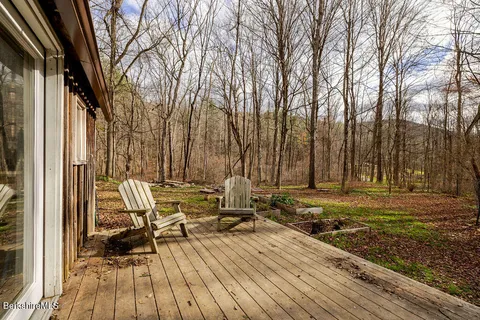 a view of a patio with table and chairs and wooden floor