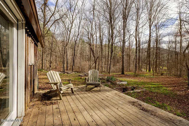 a view of a patio with table and chairs and wooden floor