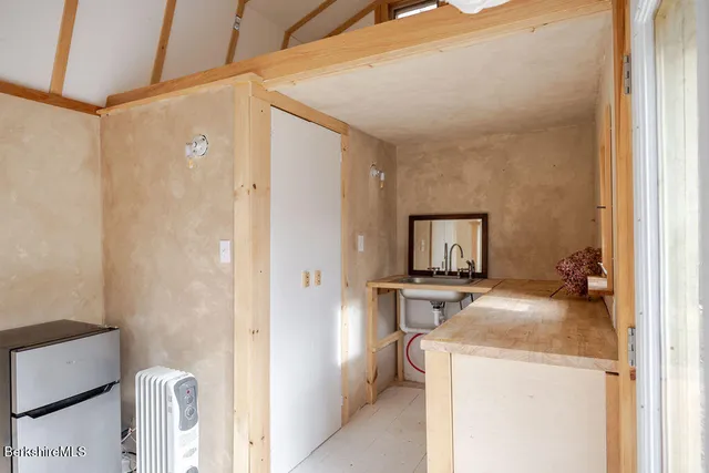 a room that has a sink and a bed in it