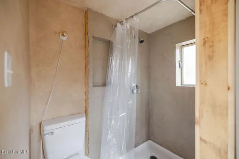 a bathroom with a shower and a glass door