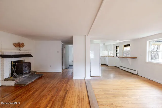 a view of a room with wooden floor and fireplace