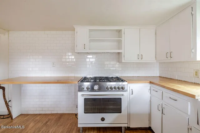 a stove top oven sitting inside of a kitchen