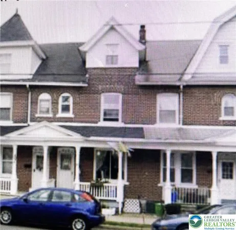 a front view of a residential apartment building with a yard