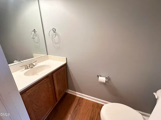a bathroom with a sink mirror vanity and toilet