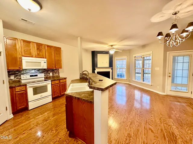 a kitchen with stove and cabinets