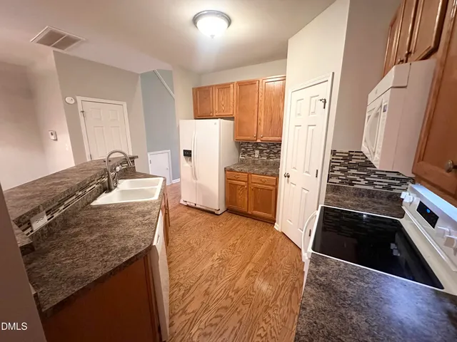 a kitchen with a stove and a refrigerator
