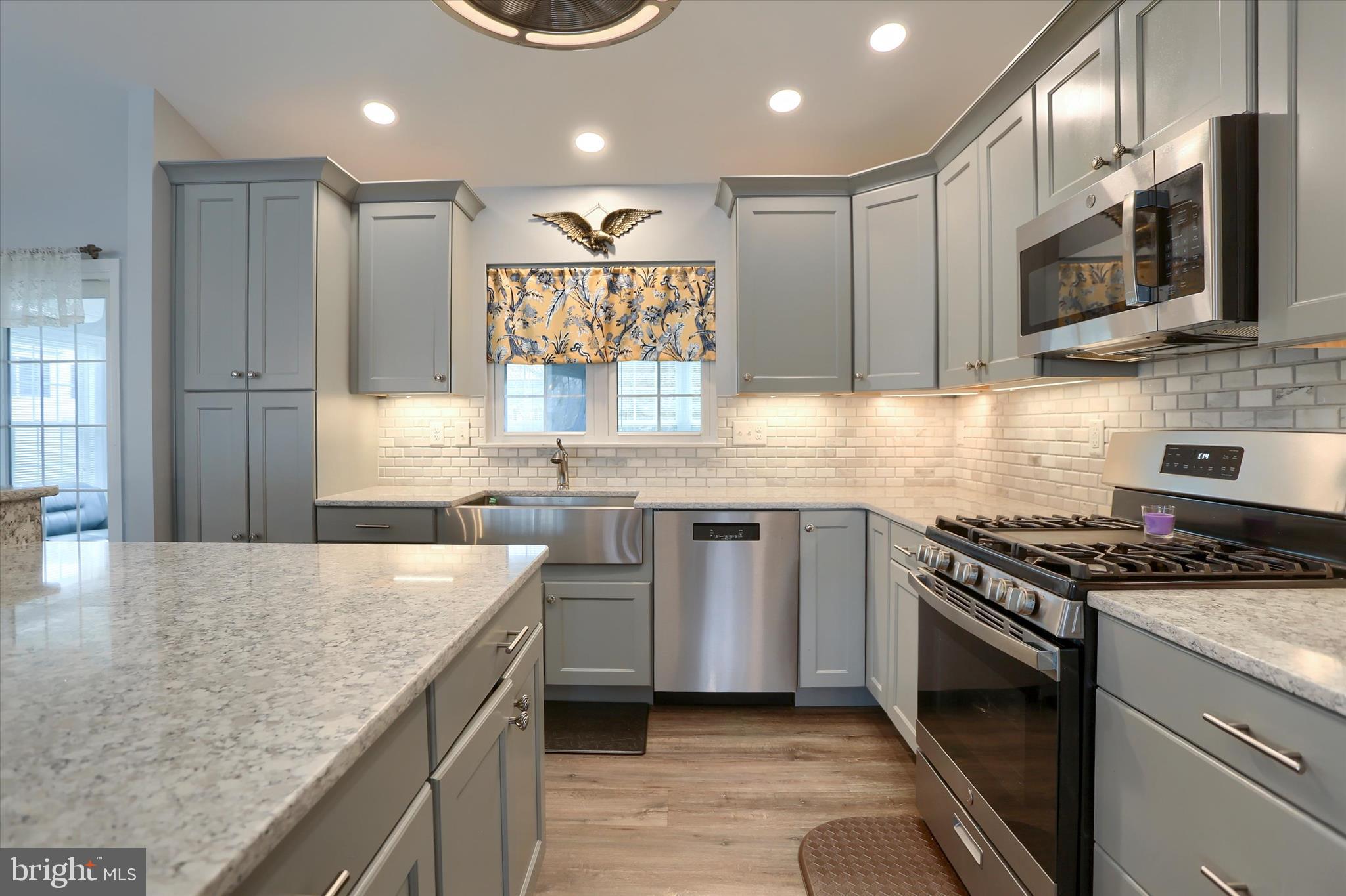 26 Rye Lane Palmyra, PA 17078 - Photo 18 of 52 a kitchen with stainless steel appliances granite countertop a stove a sink and a microwave