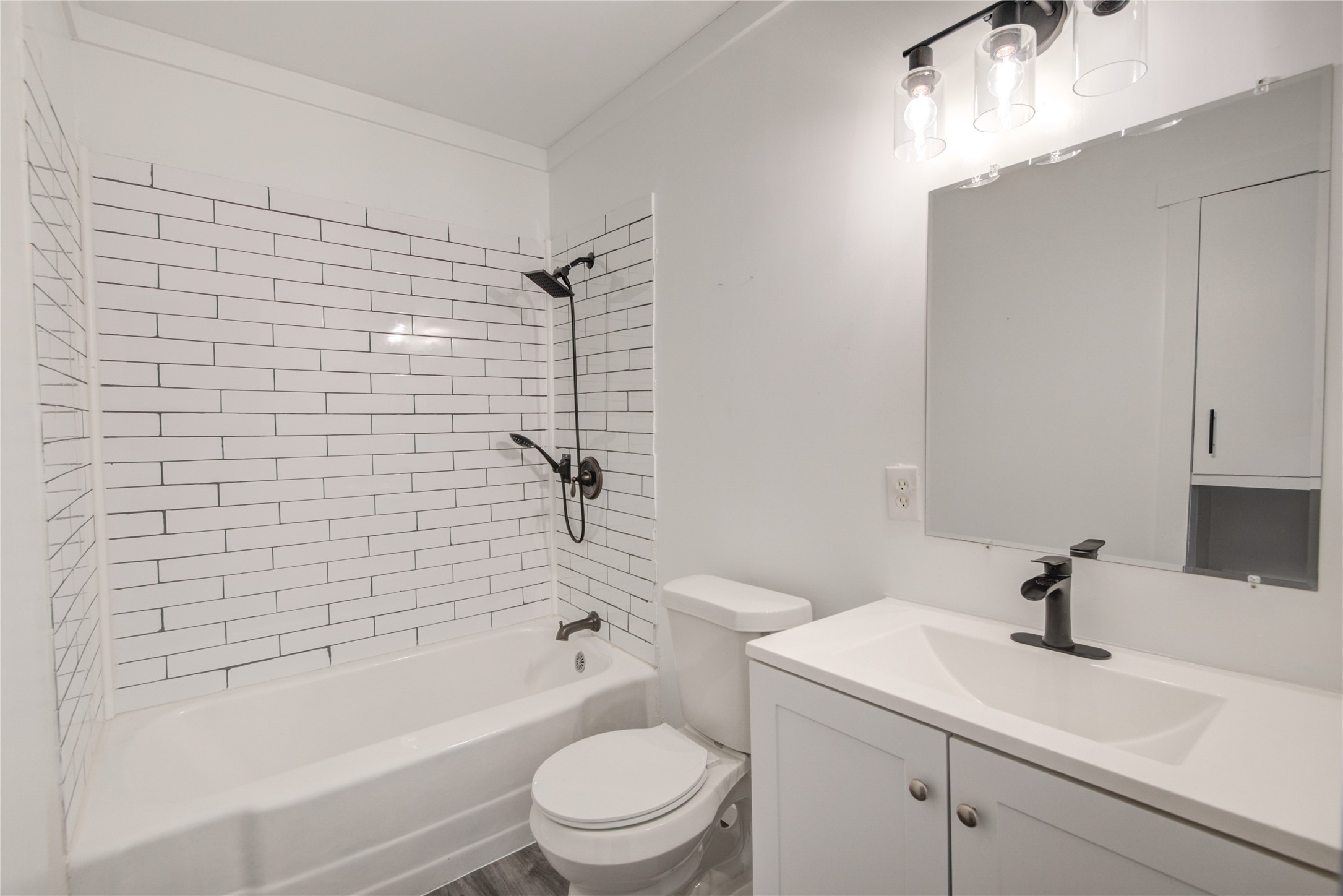 609 Hurst Place Angleton, TX 77515 - Photo 23 of 36 a bathroom with a sink a toilet and shower