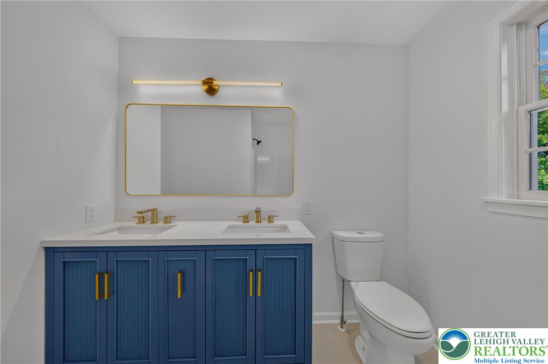 3130 Muirfield Road Center Valley, PA 18034 - Photo 41 of 63 A contemporary vanity with gold hardware and integrated sinks defines this refreshed bathroom space.