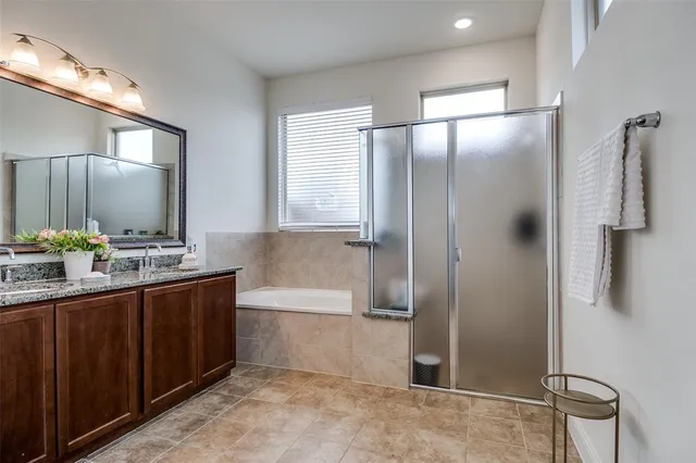 a spacious bedroom with a bed and a chandelier