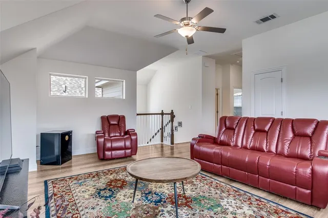 a living room with furniture a rug and a chandelier