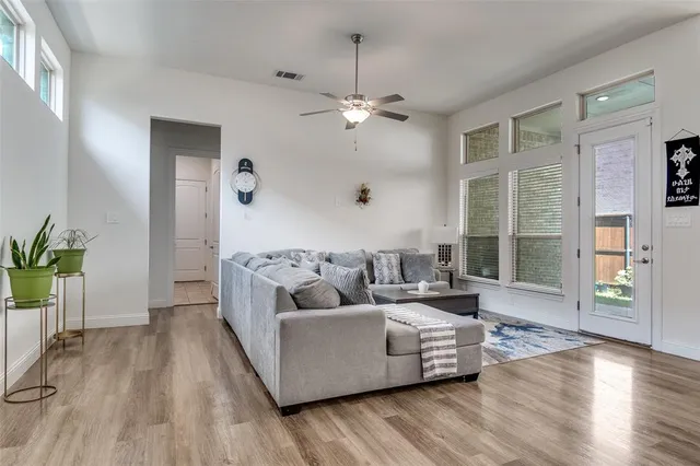 a view of a room with kitchen view and a wooden floor
