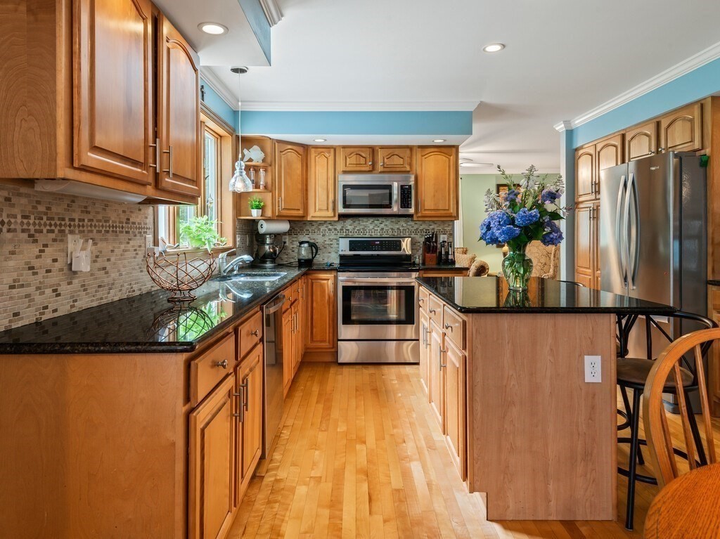 9 Santom Street Auburn, MA 01501 - Photo 6 of 42 a kitchen with stainless steel appliances granite countertop a stove a sink and a refrigerator