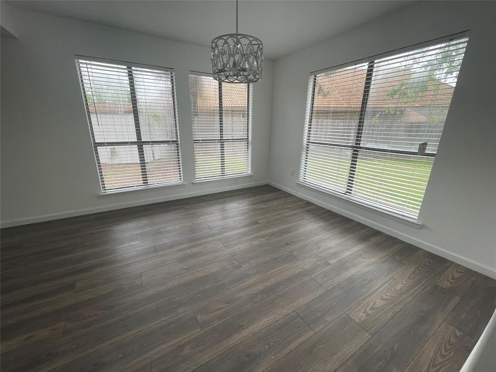 3 Ridge Drive Hickory Creek, TX 75065 - Photo 6 of 20 a view of an empty room with wooden floor and a window