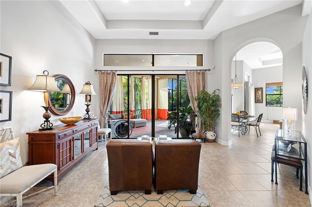6513 Caldecott Drive Naples, FL 34113 - Photo 12 of 33 a living room with furniture and a large window
