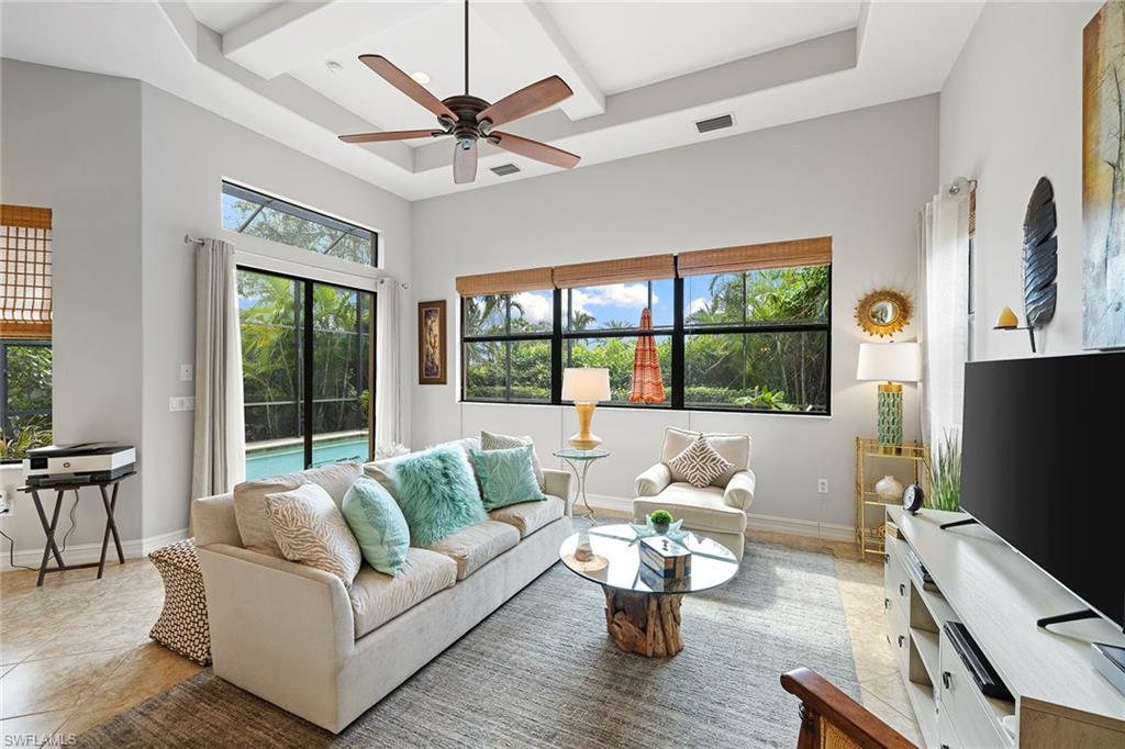 6513 Caldecott Drive Naples, FL 34113 - Photo 19 of 33 a living room with furniture flat screen tv and a large window