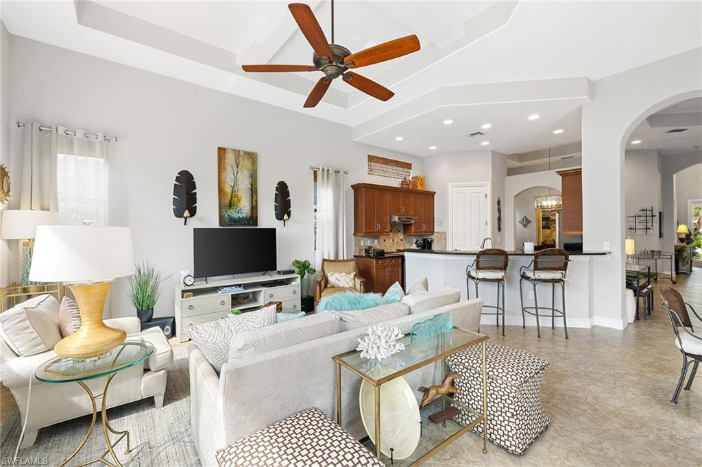 6513 Caldecott Drive Naples, FL 34113 - Photo 21 of 33 a living room with furniture and a flat screen tv
