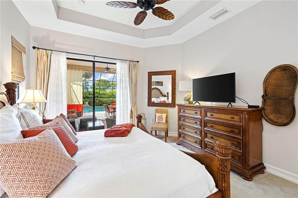 6513 Caldecott Drive Naples, FL 34113 - Photo 23 of 33 a bedroom with a bed and flat screen tv