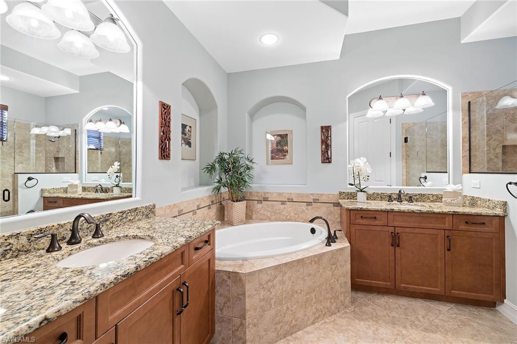 6513 Caldecott Drive Naples, FL 34113 - Photo 26 of 33 a bathroom with a granite countertop double vanity sink and a large mirror
