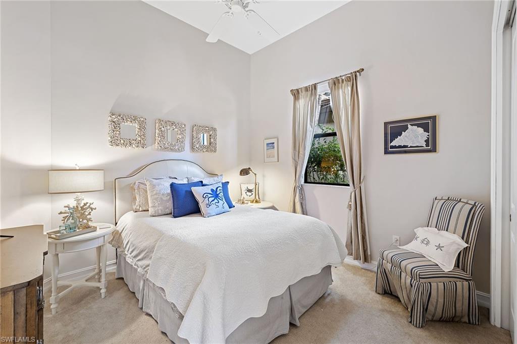 6513 Caldecott Drive Naples, FL 34113 - Photo 28 of 33 a bedroom with a bed and a couch