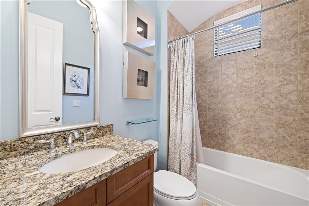 6513 Caldecott Drive Naples, FL 34113 - Photo 29 of 33 a bathroom with a granite countertop sink toilet and shower