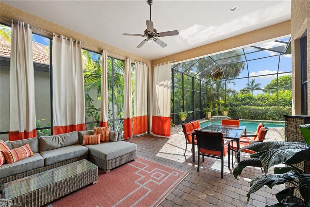 6513 Caldecott Drive Naples, FL 34113 - Photo 3 of 33 a living room with patio furniture and a floor to ceiling window