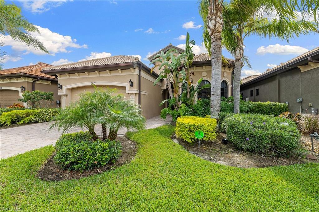 6513 Caldecott Drive Naples, FL 34113 - Photo 7 of 33 a view of a house with a yard and potted plants