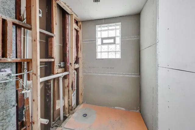 a bathroom with a tub and a window