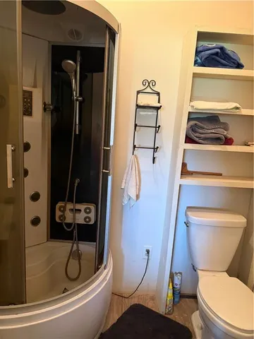a bathroom with a toilet and a shower
