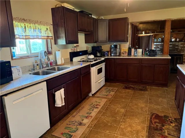 a kitchen with stainless steel appliances granite countertop a sink stove and cabinets