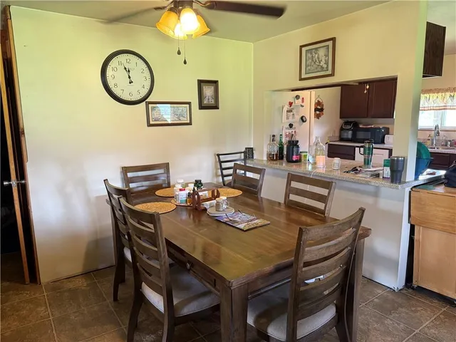 a view of a dining room with furniture and a chandelier