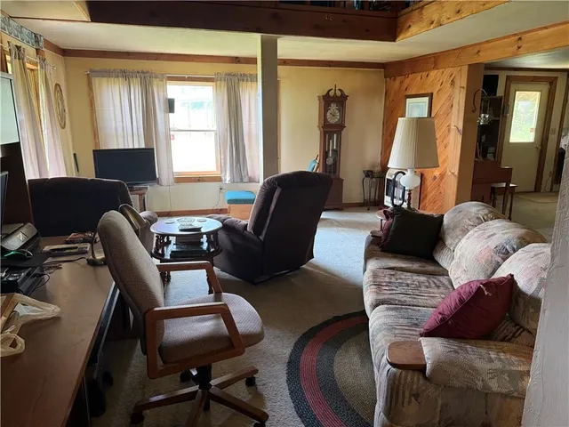 a living room with furniture rug and a window