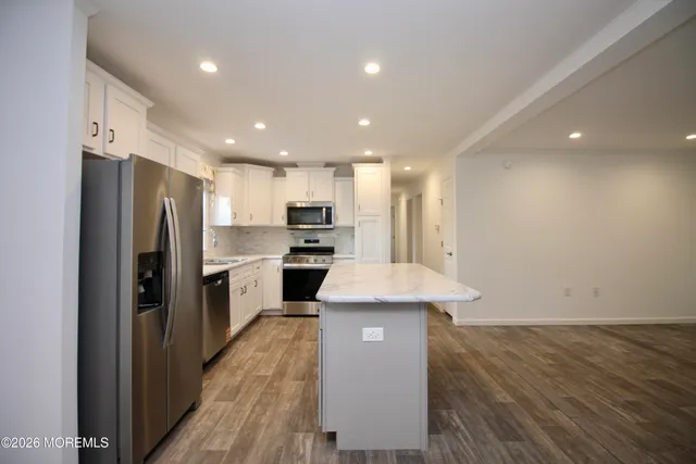a kitchen with a refrigerator and a sink
